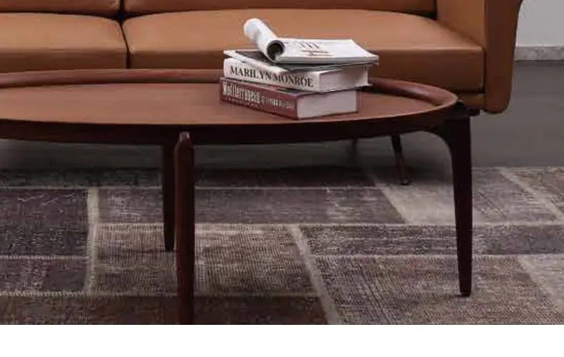 Curved coffee table in front of a sofa from the NEAT collection by Knights Craft