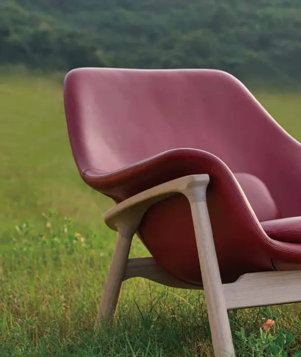Red lounge chair with curved armrests from the OASIS collection by Knights Craft