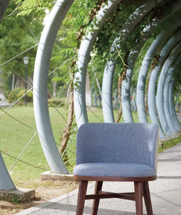 Upholstered chair with a curved back in the REBORN collection by Knights Craft